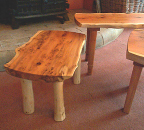 Photograph of some tables in rustic style with character wood tops