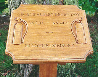 Photograph of a decorated wooden memorial plaque