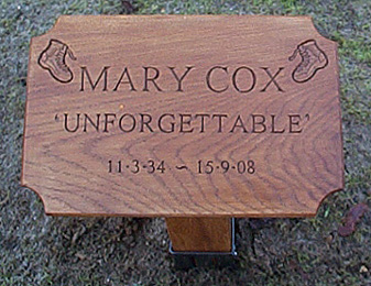 Photograph of a decorated wooden memorial plaque